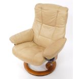 An Ekornes Stressless swivel armchair, raised on a circular base. (AF)