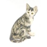 A Winstanley style pottery figure of a seated cat, in black mottled decoration, the eyes picked out