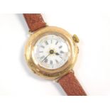 An early 20thC 14ct gold cased wristwatch, circular enamelled dial bearing Roman numerals, the case