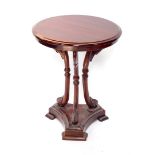 A 20thC mahogany finish hardwood occasional table, the plain circular top raised on swan necked colu