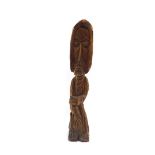 A 20thC carved figure of a standing gentleman, with beard and hood, unmarked, 42cm high.