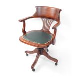 A 20thC mahogany swivel office captain's chair, with scroll top, inverted pierced vertical splat, st