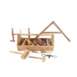 A carpenter's tool box, containing a band saw, planes, mallets, chisels, etc., 63.5cm wide.