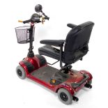 An Invacare Lynx Victory four wheeled mobility scooter, in red and black colourway, with front baske