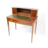 A Sheraton style mahogany and birds eye maple desk, the galleried top with an open section raised ab