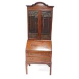 A 20thC mahogany bureau, the shaped fall with moulded outline revealing a fitted interior of drawers