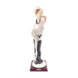 A Capo di Monte Florence figure of a lady, designed by Giuseppe Armani, modelled standing holding a