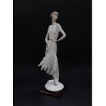 A Capo di Monte Florence figure of a lady, designed by Giuseppe Armani, modelled standing holding a
