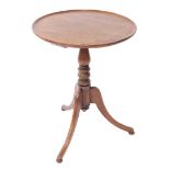 A George III style mahogany wine table, the circular shallow dish top on a baluster stand terminatin