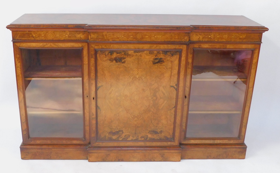 A Victorian figured and burr walnut veneered breakfront credenza, with mahogany cross banded and str