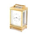 A brass carriage clock by De la Grense, of conventional form, dial bearing Roman numerals, case pres