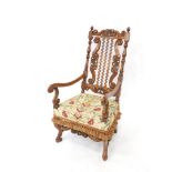 A 19thC heavily carved walnut throne type armchair, with a pierced floral and scroll cresting rail,