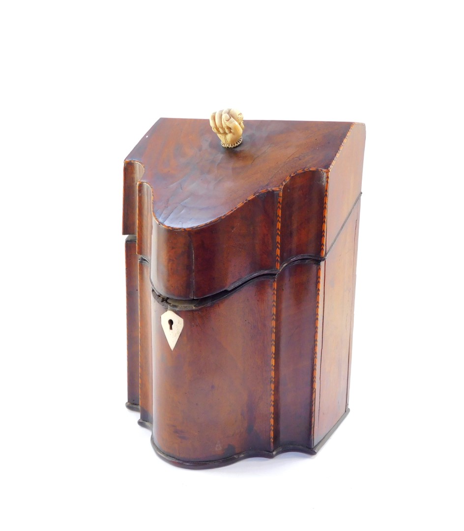 A George III mahogany and box wood strung serpentine knife box, with ivory fist handle, and plain in