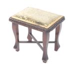 A late Victorian oak stool, of oblong form, with heavily carved acanthus leaf outline, overstuffed s