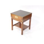 A 20thC mahogany campaign style side table, with tooled leatherette top, raised above a drawer, with