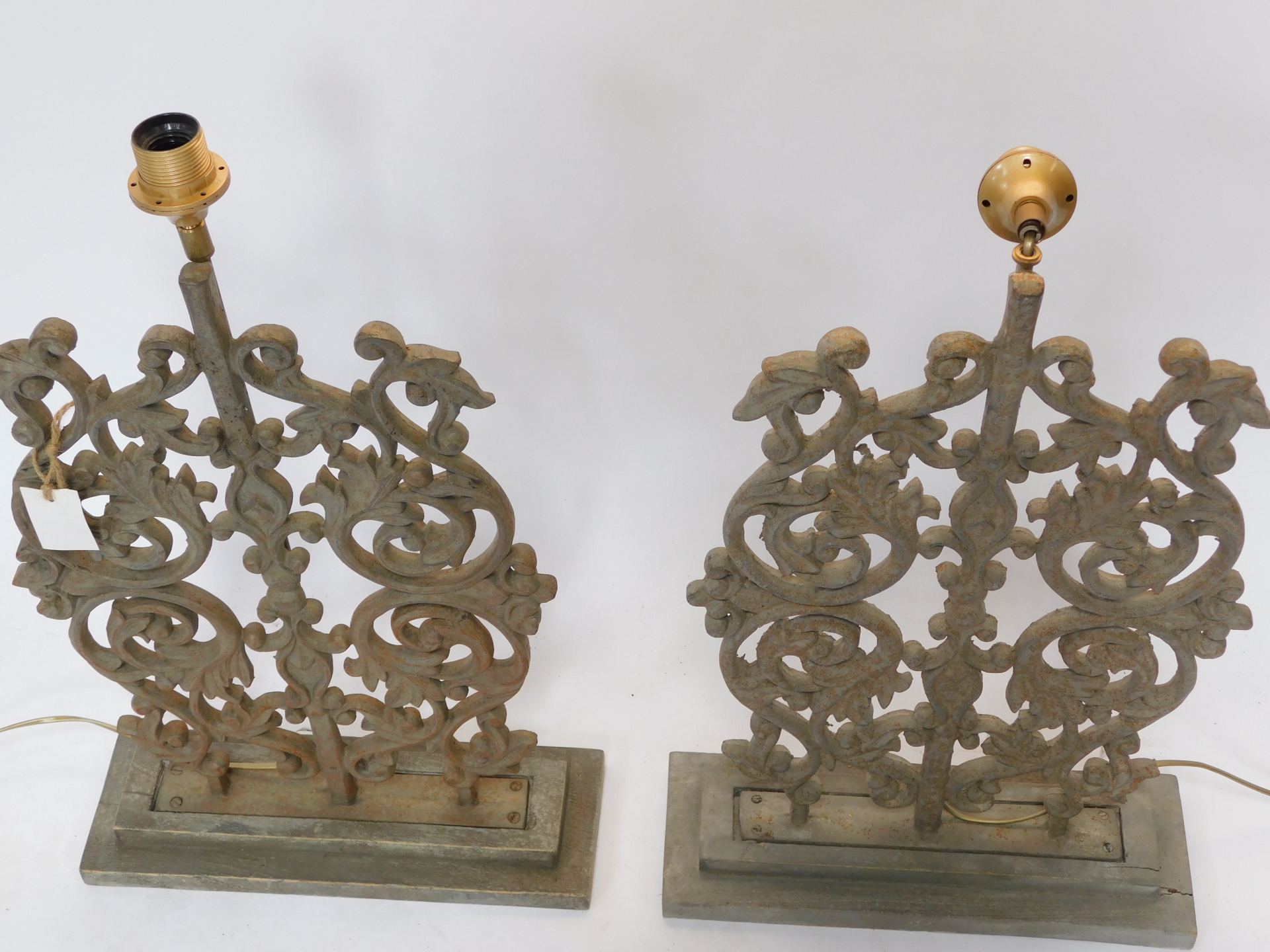 A pair of 20thC iron table lamps, each set with a regal style arrangement of scrolls, orbs and flowe - Image 2 of 2