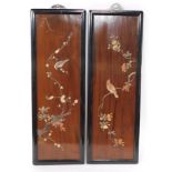 A pair of Japanese wooden and shibyama panels, raised with birds and flowering branches, in ebonised