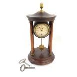A German early 20thC wooden cased portico clock, circular dial bearing Arabic numerals, the case rai