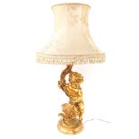 A 20thC plaster finish rococo table lamp, formed as a figure of a child, entwined stem, on a circula