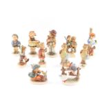 A group of Hummel figures, including Sister., Happiness., Apple Tree Girl., and Little Gardener. (11