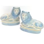 A pair of Rye Pottery models of lions, in recumbent pose, on an oval base, plated mark, 17.5cm wide.