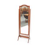 A 20thC mahogany cheval mirror, with arched top and bevelled glass, flanked by tapering supports on