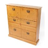 A 20thC pine shoe rack, of rectangular form with three hinged cupboards to the front on a block base