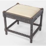 A 19thC Dutch ebony stool, with Arabesque channeled carved top, with scroll and griffin frieze suppo
