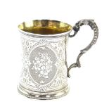 A Victorian silver tankard, with foliate scroll handle, engraved with panels of flowers, central res