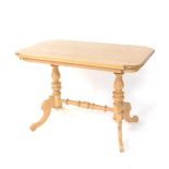 A pine table, with shaped top, raised above a double baluster joined with a horizontal cylindrical s