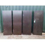 Eight stained panelled wooden doors, with latch or door handles, 204cm high, 72.5cm wide.