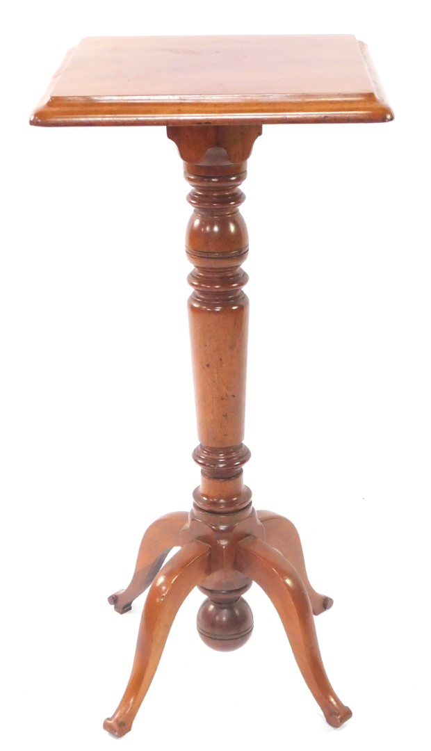 A Victorian mahogany jardiniere stand, with a wide moulded top, raised on a turned stem, terminating