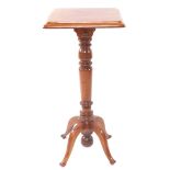 A Victorian mahogany jardiniere stand, with a wide moulded top, raised on a turned stem, terminating