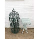 A green cast iron wine rack, of cylindrical bird cage form, 107cm high., together with a pale green