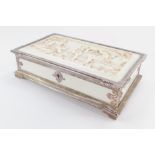 A Victorian silver and ivory box, of rectangular form, the lid heavily carved with three cherubs pla