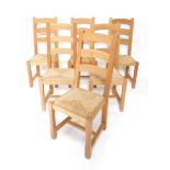 A set of six 20thC Cotswold style light oak dining chairs, with horizontal back splats, shaped front