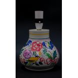 A 20thC Poole pottery table lamp, traditionally decorated with birds and flowers, 17cm high.