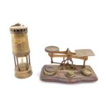 A set of early 20thC brass postal scales, with weights, together with a Cambrian Works Miners Lamp b