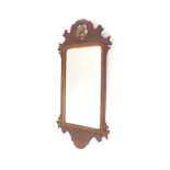 An early 19thC mahogany and giltwood fret mirror, the shaped cornice centred by stylised scroll pier