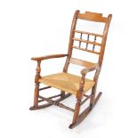 A late 19thC ash and elm rocking chair, with shaped cresting rail, above three horizontal splats, br