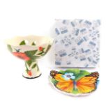 A Blue Sky pottery pedestal bowl decorated in the Hibiscus pattern, against a cream ground, printed