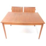 A vintage teak draw leaf dining table, of rectangular form with a wide cross banding, raised on tape