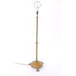 An early 20thC brass Art Nouveau lamp standard, with plain cylindrical stem broken by a shaped mould