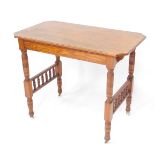 A 19thC pitch pine side table, the canted rectangular top raised on cylindrical legs joined by a dou