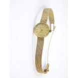 A Tissot lady's 9ct gold cased wristwatch, circular dial with gold batons, on a mesh bracelet strap
