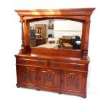 A Victorian mahogany mirror back sideboard, the outswept pediment with egg and dart moulding, the ba