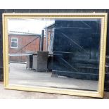A modern gilt framed rectangular wall mirror.