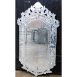 A modern etched glass wall mirror, of rectangular shape with various scroll decorations, inlaid with