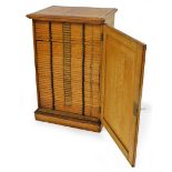A 19thC oak microscope slide cabinet, the plain door revealing forty drawers, with vacant metal card