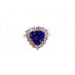 An 18ct white gold trilliant tanzanite and diamond cluster ring, the tanzanite totalling approximate